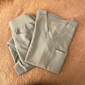 FIGS Technical Collection V-Neck Scrub Top and Jogger Bottom in cement color